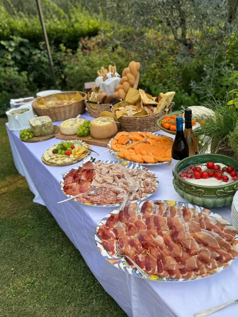 A table outdoors filled with assorted appetizers and snacks.