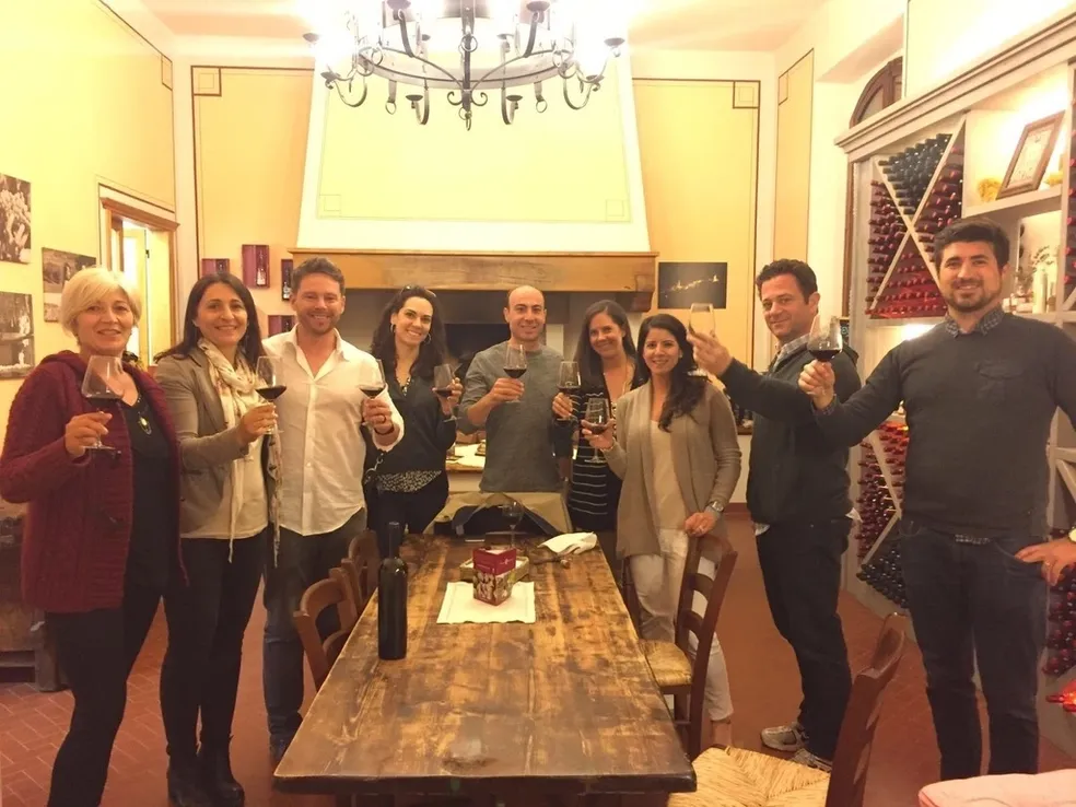 Group of friends celebrating together indoors with drinks.